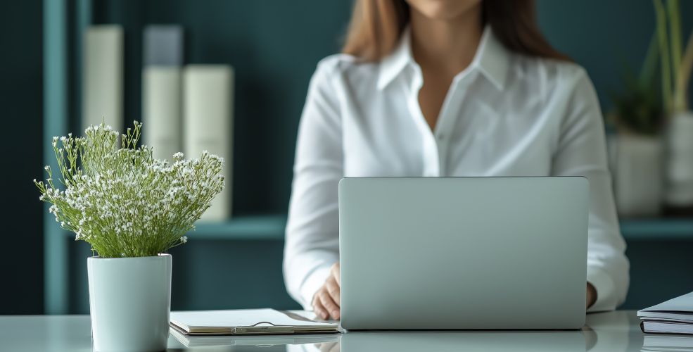 Woman working at a laptop, representing business structure and clarity